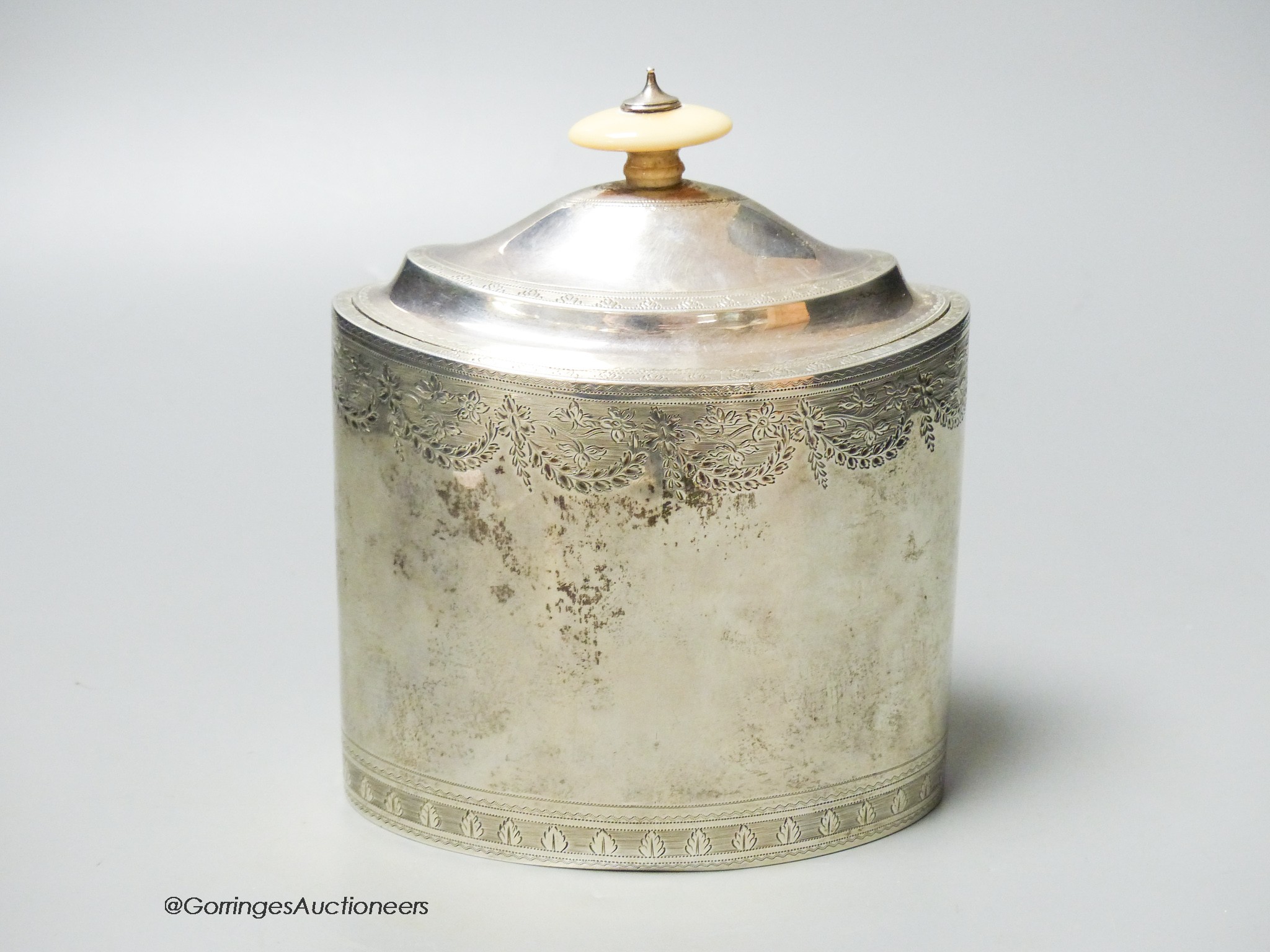 A George III engraved oval tea caddy, with ivory knop, no key, Henry Nutting, London, 1796, length 13.4cm, gross weight 12.5oz.